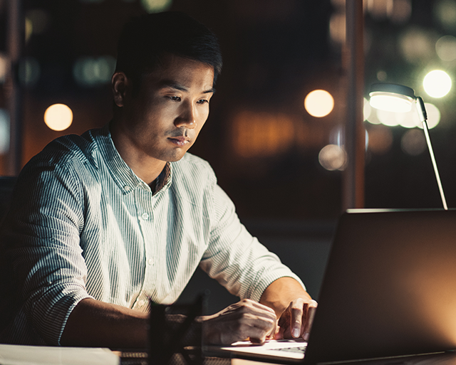A sales team member is working on the laptop